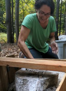 Theresa Smith creating molds in the forest