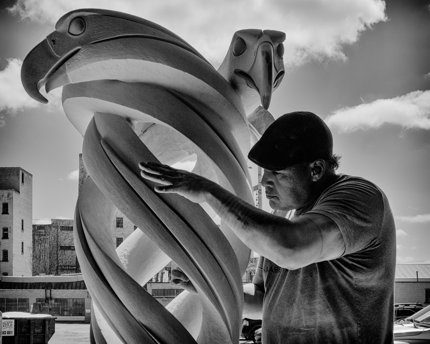Artist Jason Quigno at work on a stone sculpture. Photo by Eric Bouwens